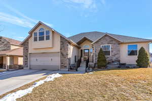 View of front of home with driveway, an attached garage, a shingled roof, and stucco siding