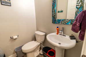 Half bath featuring a sink and toilet