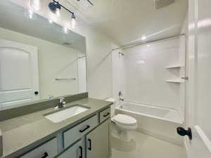 Full bath featuring toilet, tub / shower combination, vanity, and visible vents