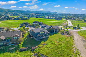 Birds eye view of property featuring view of golf course and a mountain view