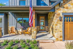 Property entrance featuring stone siding and board and batten siding