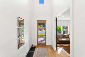 Entrance foyer with baseboards and light wood finished floors