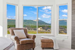 Sunroom featuring a residential view and a mountain view