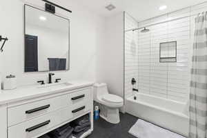 Full bathroom with toilet, recessed lighting, vanity, visible vents, and shower / bath combo with shower curtain