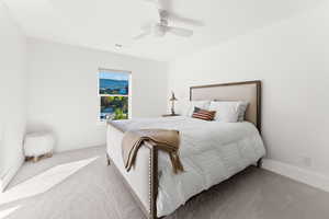 Bedroom featuring baseboards, visible vents, a ceiling fan, and light colored carpet