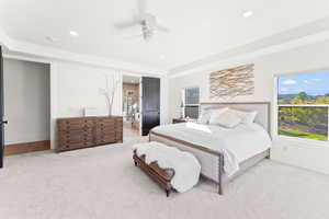 Bedroom featuring a ceiling fan, recessed lighting, light carpet, and a tray ceiling