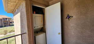 Laundry area featuring laundry area and stacked washer / dryer