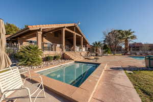 Pool featuring a patio, stairway, and fence