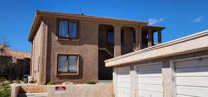 View of front facade featuring a garage and stucco siding