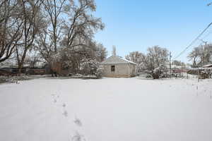 Snowy yard featuring fence