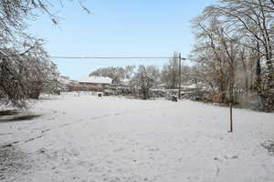 Yard covered in snow with a garage