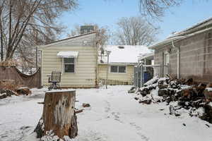 Snow covered property featuring a gate and fence