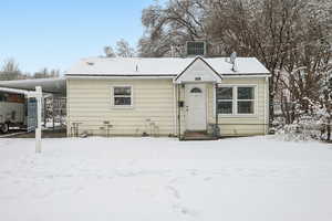 Bungalow-style house featuring central AC and an attached carport