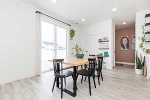 Dining area with light wood-style flooring, baseboards, and recessed lighting