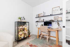 Office area featuring baseboards and wood finished floors