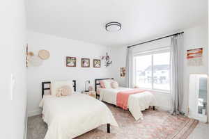 Carpeted bedroom featuring baseboards