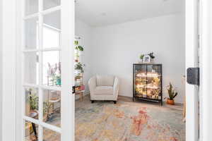 Sitting room with baseboards and wood finished floors