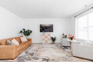 Living area with baseboards and wood finished floors