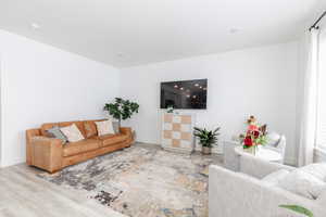 Living room with baseboards and wood finished floors