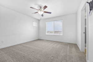 Unfurnished bedroom with ceiling fan, carpet floors, and baseboards