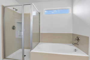 Bathroom with a stall shower and a garden tub