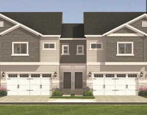 View of front of home with driveway and a garage