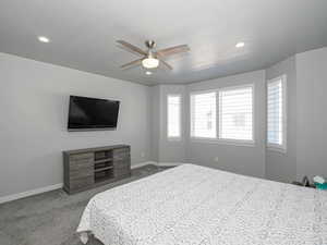 Bedroom featuring light carpet, baseboards, a ceiling fan, and recessed lighting