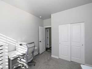 Office space featuring baseboards and light colored carpet