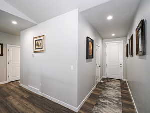 Hall featuring recessed lighting, dark wood finished floors, visible vents, and baseboards