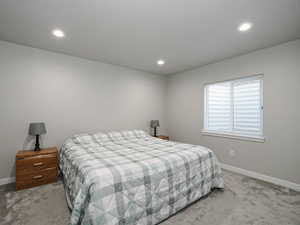 Bedroom featuring recessed lighting, baseboards, and light colored carpet