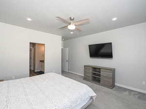 Bedroom with recessed lighting, light carpet, ceiling fan, and baseboards