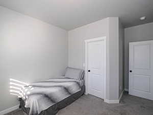 Carpeted bedroom with baseboards