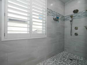 Bathroom featuring tiled shower