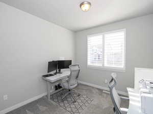 Carpeted office space featuring baseboards