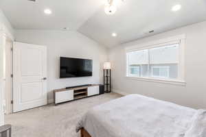 Bedroom with recessed lighting, light colored carpet, visible vents, vaulted ceiling, and baseboards