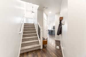 Stairway featuring hardwood / wood-style floors, recessed lighting, visible vents, and baseboards