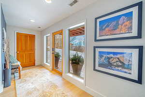 Entrance foyer with baseboards, light wood-style flooring, visible vents, and recessed lighting