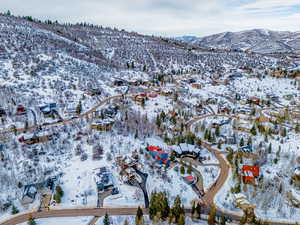 Snowy aerial view with a residential view and a mountain view