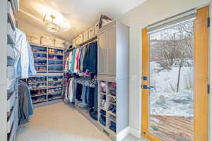 Walk in closet featuring carpet floors and lofted ceiling