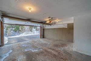 Garage with a textured wall and a garage door opener