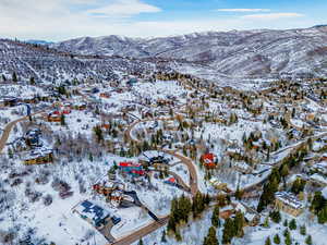 Snowy aerial view with a residential view and a mountain view