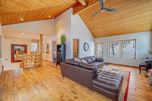 Living area featuring light wood finished floors, wood ceiling, and a wealth of natural light