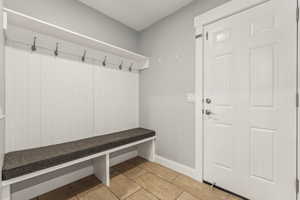 The mud room also offers an attached half bath