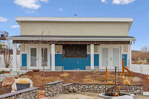 Detached garage has covered patios and front and back roll up garage doors