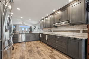 Custom lower cabinets include a pull out corner lazy Susan for easy in cooking