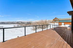 Snow covered deck with a mountain view