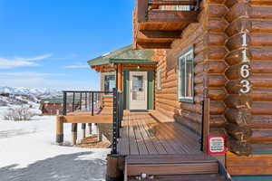 Snow covered deck featuring a mountain view