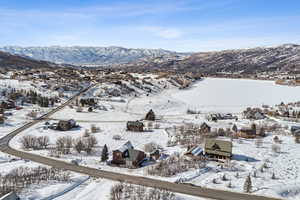 Snowy aerial view with a residential view and a mountain view