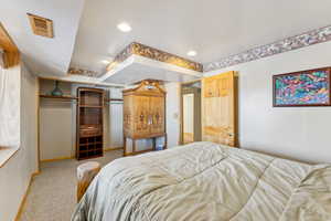 Bedroom with light carpet, visible vents, a closet, and recessed lighting