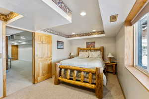 Bedroom with recessed lighting and light colored carpet